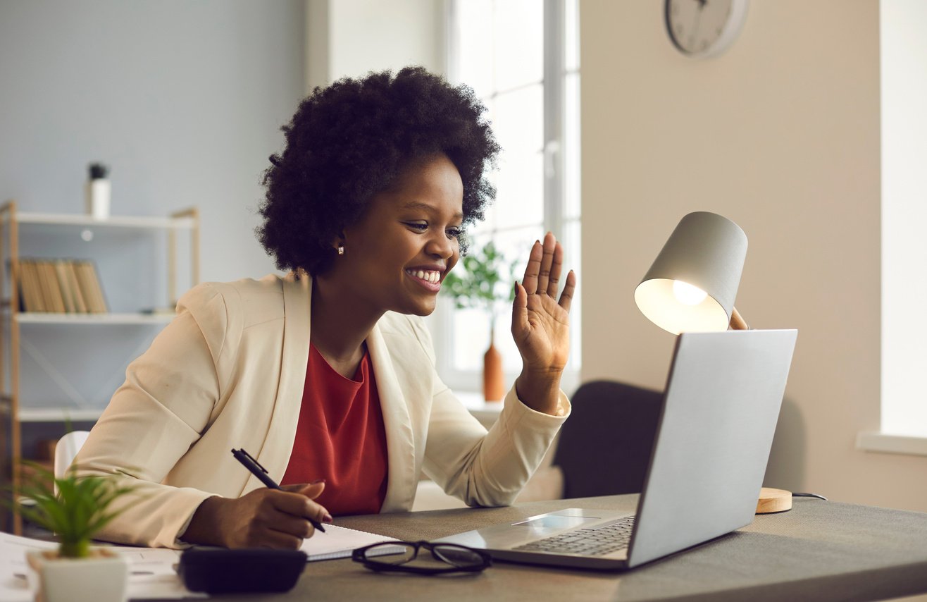 Friendly African American Businesswoman Holds an Online Meeting While Sitting in the Office.